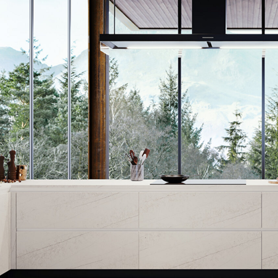a kitchen island in Quarztforms Lasa and a large window behind