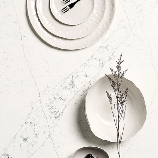 a close-up of a Quartzforms Poseidon worktop with plates on top