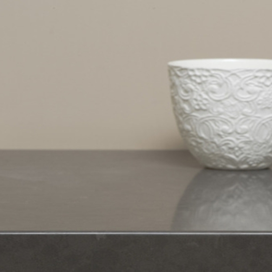 a Caesarstone Raven 30mm worktop and a beige wall behind
