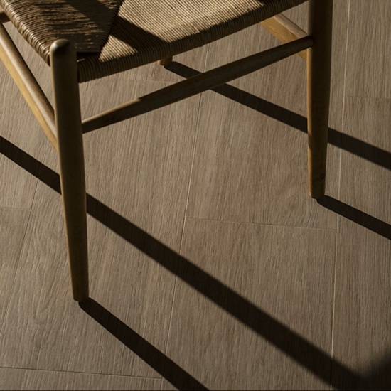 Close-up of chair on Dekton Kedar wood-effect flooring with shadow