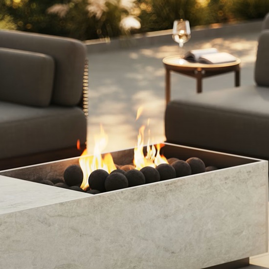Dekton Nara worktop used in modern outdoor fire pit design for affluent UK homes in Kensington, featuring durable ultra-compact stone from Cosentino with natural beige veining for heat-resistant patios.