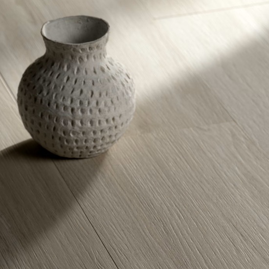 Textured vase on Dekton Zira wood-effect flooring with shadow