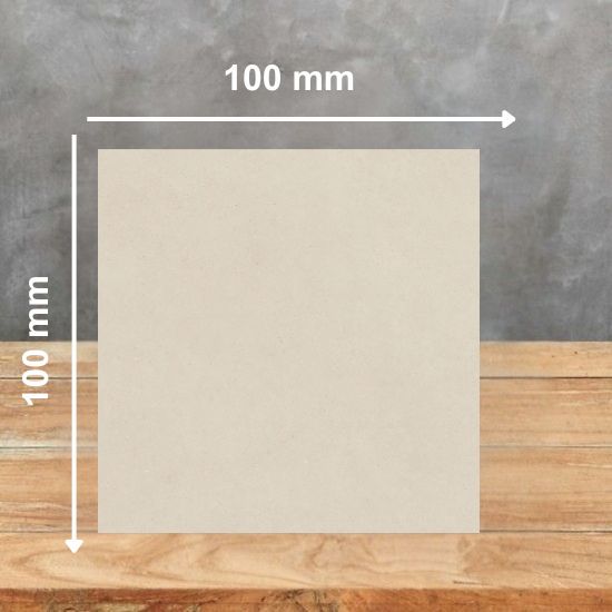 100mm x 100mm sample tile of Neolith Creme sintered stone displaying soft cream tone and subtle texture details