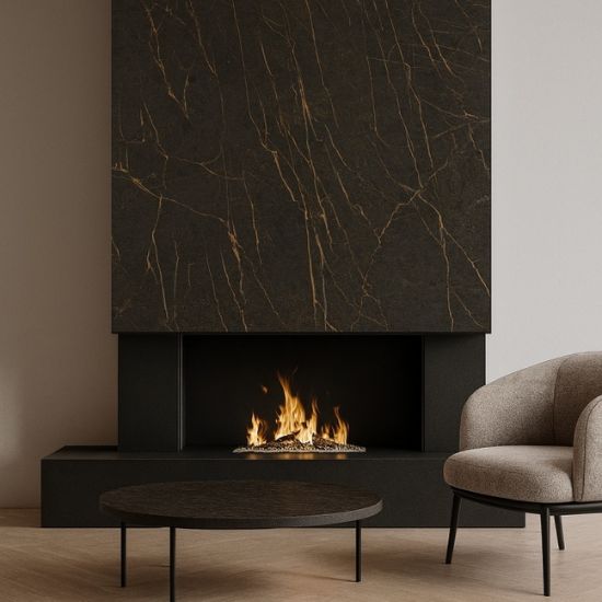 Neolith Mamba fireplace surround in black with gold veining, modern fire, coffee table, and armchair in neutral room