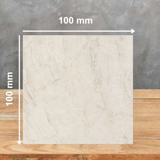 100mm x 100mm sample tile of Neolith Taj Mahal sintered stone highlighting creamy white base and golden veining