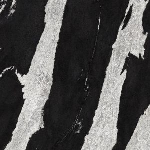 lose-up of Neolith Victoria sintered stone showing deep black with white veining, adorned with branches, marble hexagon, and wooden accents