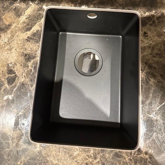 Black undermount sink installed in brown marble effect porcelain worktop by Worktop Library in Banstead kitchen