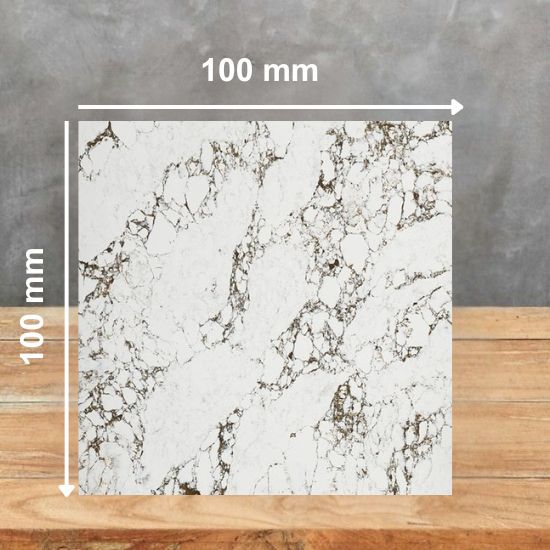 0 mm square sample of Arabescato Levanto Supreme quartz in white with brown and grey veining, on a wooden table with grey background
