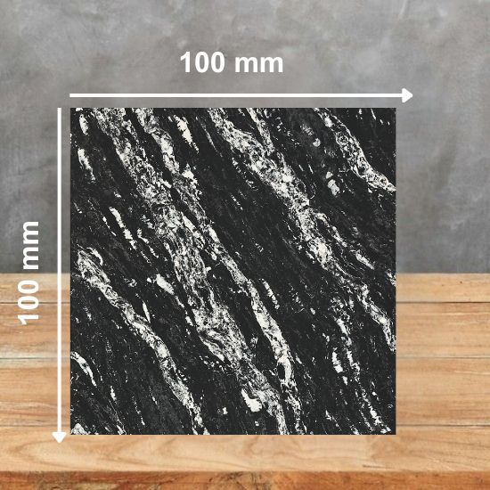 100 mm square sample of Black Forest quartz in black with white veining, placed on a wooden surface against a grey background
