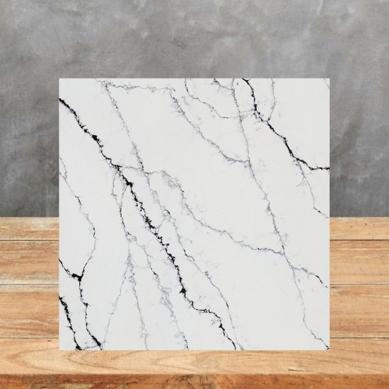 Square sample of Calacatta Black quartz in white with black veining, placed on a wooden surface against a grey background from the Essex Quartz Collection