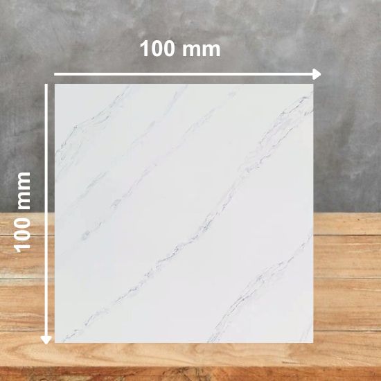 100 mm square sample of Calacatta Ophelia quartz in white with grey veining, placed on a wooden surface against a grey background