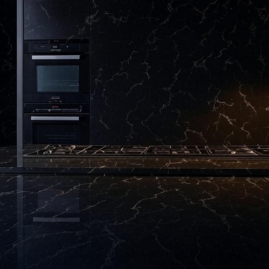 xtCarrara Nero quartz kitchen worktop in white with fine black veins, featuring wooden cabinets, pendant lights, sink, oven, and lemon bowl in a contemporary kitchen setting