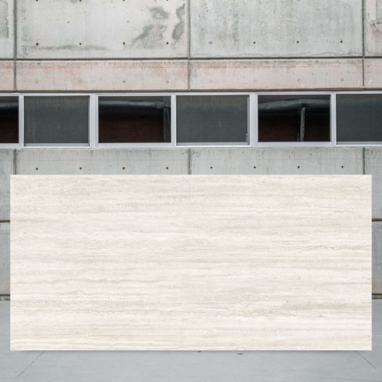 ull slab of Techlam Travertino Pearl measuring 320 x 160 cm against concrete background