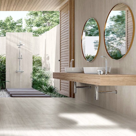 Techlam Travertino Pearl sintered stone flooring in contemporary outdoor bathroom with floating wooden vanity and outdoor shower
