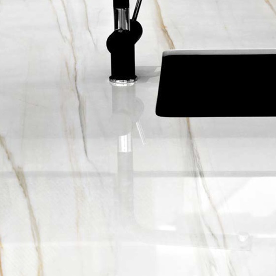 Techlam Macchia Gold countertop with black faucet and integrated sink in polished finish
