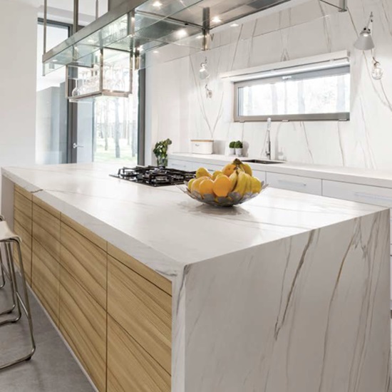 Techlam Macchia Gold kitchen island countertop with fruit bowl in contemporary white kitchen