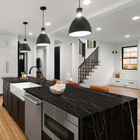 Techlam St. Laurent black marble-effect countertop on kitchen island with white cabinetry and pendant lights