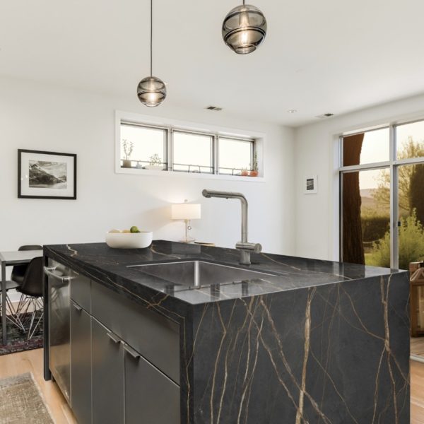 Techlam St. Laurent worktop on contemporary kitchen island with integrated sink and modern lighting