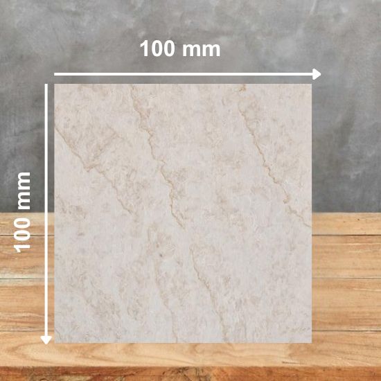 100 mm square sample of Taj Mahal Highlands Quartz, creamy white base with gold and beige veins in marble-effect pattern, displayed on wooden surface