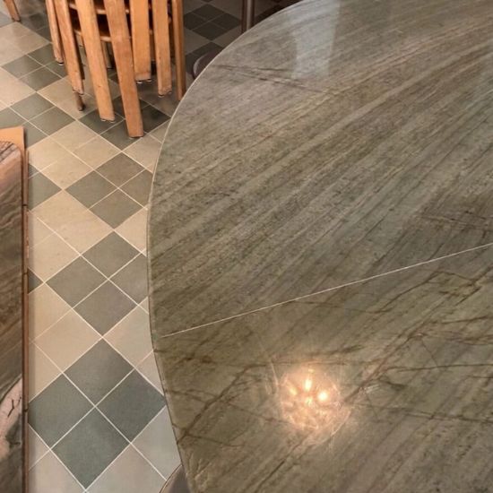 Round polished Green Maestro Quartzite table top with dramatic green veining and light reflection