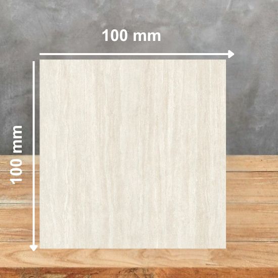 100 mm square sample tile of Sapienstone Travessa in light beige travertine-effect with linear veining, displayed on wooden surface
