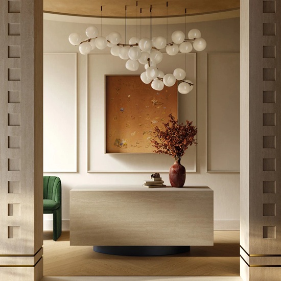 Sapienstone Travessa console table in light beige travertine-effect with natural linear veining, styled with art, vase and modern lighting in an elegant curved hallway