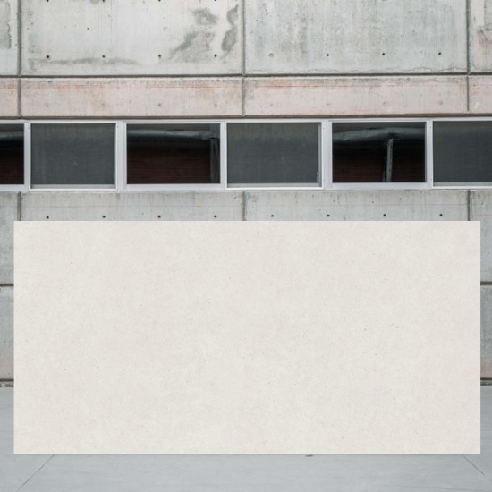 Large slab of Techlam Limestone by Levantina in soft light grey with natural limestone texture, displayed in modern warehouse setting