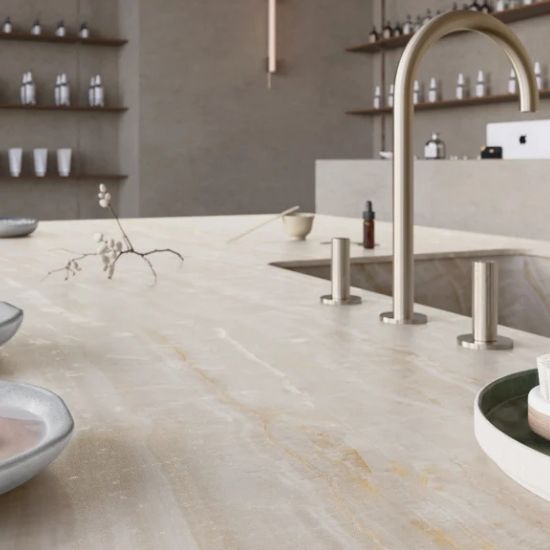 Close-up of Caesarstone Onyxa kitchen worktop surrounding an integrated sink with modern tap and minimalist styling in a luxury kitchen.
